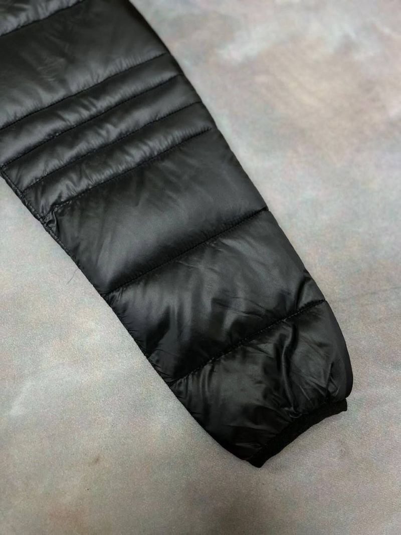 Stay warm and stylish in cold weather with the Canada Goose Glossy Black Puffer Jacket. Featuring a lightweight quilted design with premium insulation, a protective hooded collar, and signature branding accents, this outerwear piece combines everyday functionality with luxury cold-weather style. - Image 9